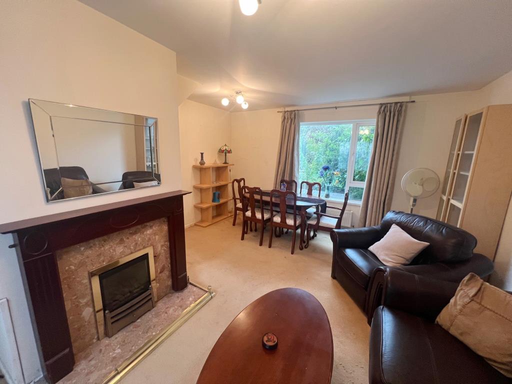 Lot: 133 - THREE-BEDROOM HOUSE FOR IMPROVEMENT - alternative angle of living/dining room with gas fireplace